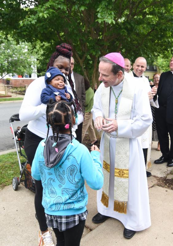 Bishop Burbidge meets Latresha, baby Shakeem, and Shantir. (May 6, 2017)