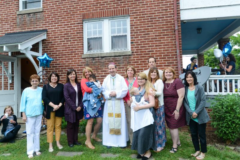 Bishop Burbidge blesses and poses with the staff and volunteers. (May 6, 2017)